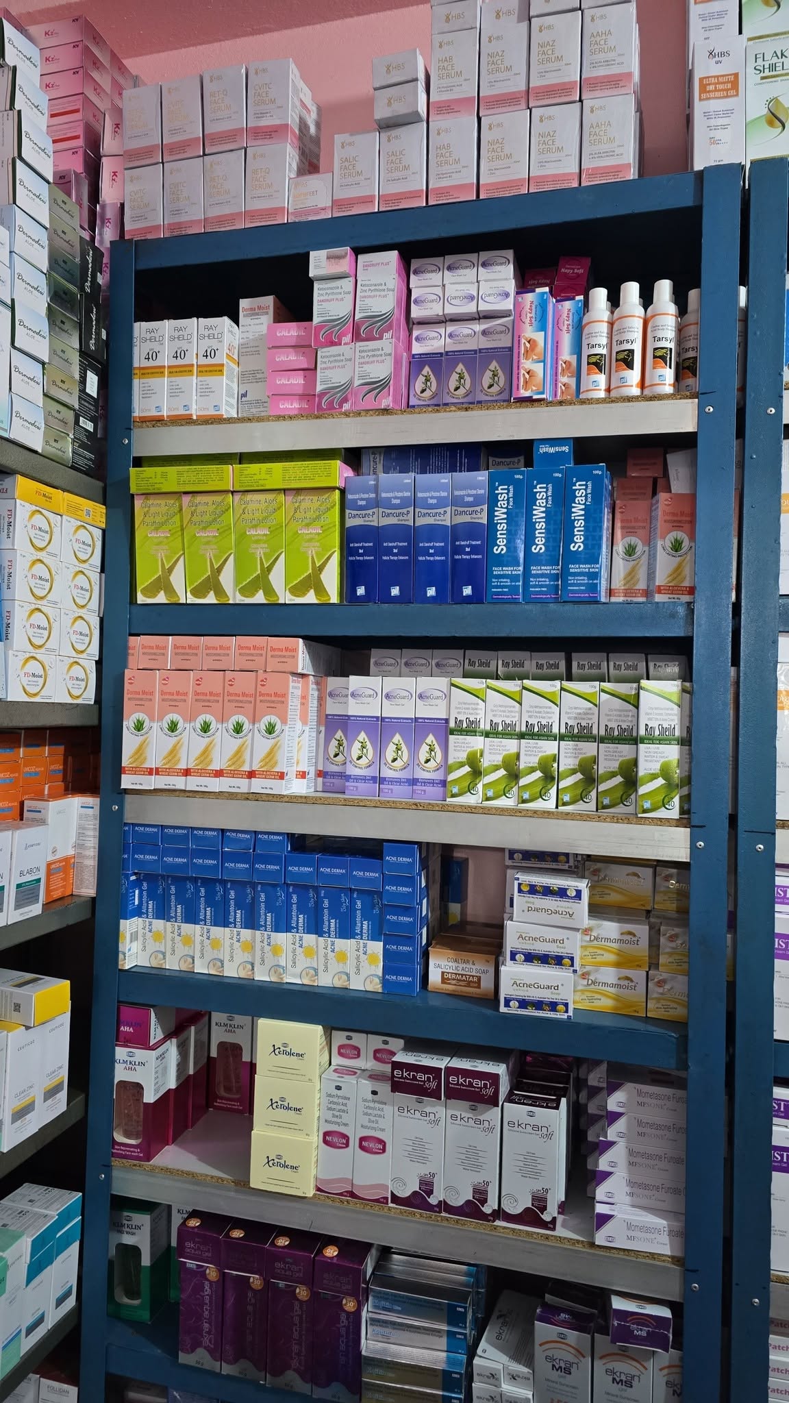 Shelves stocked with dermatology and skincare products