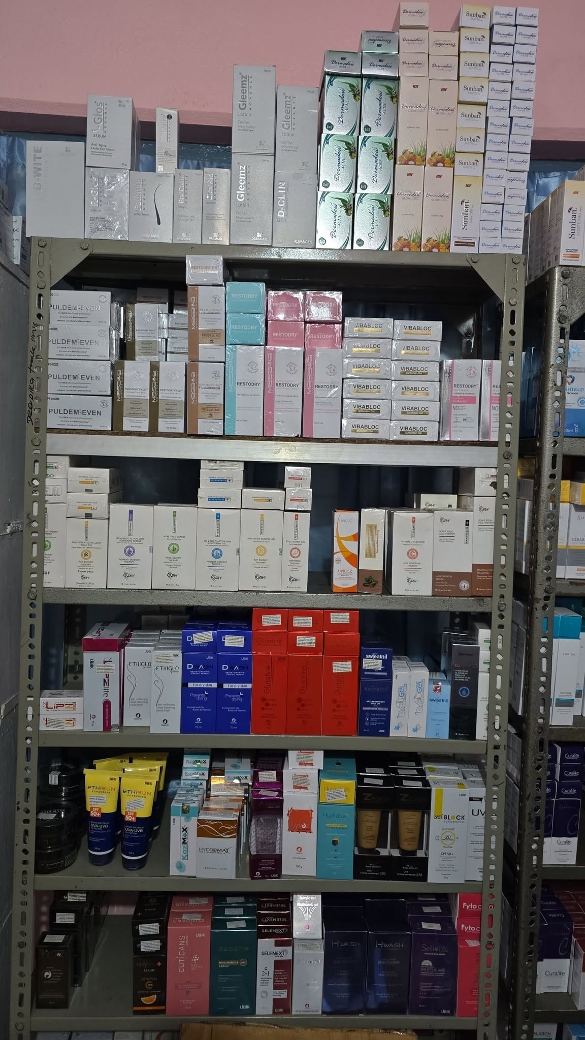 Shelves stocked with skincare and dermatology brands