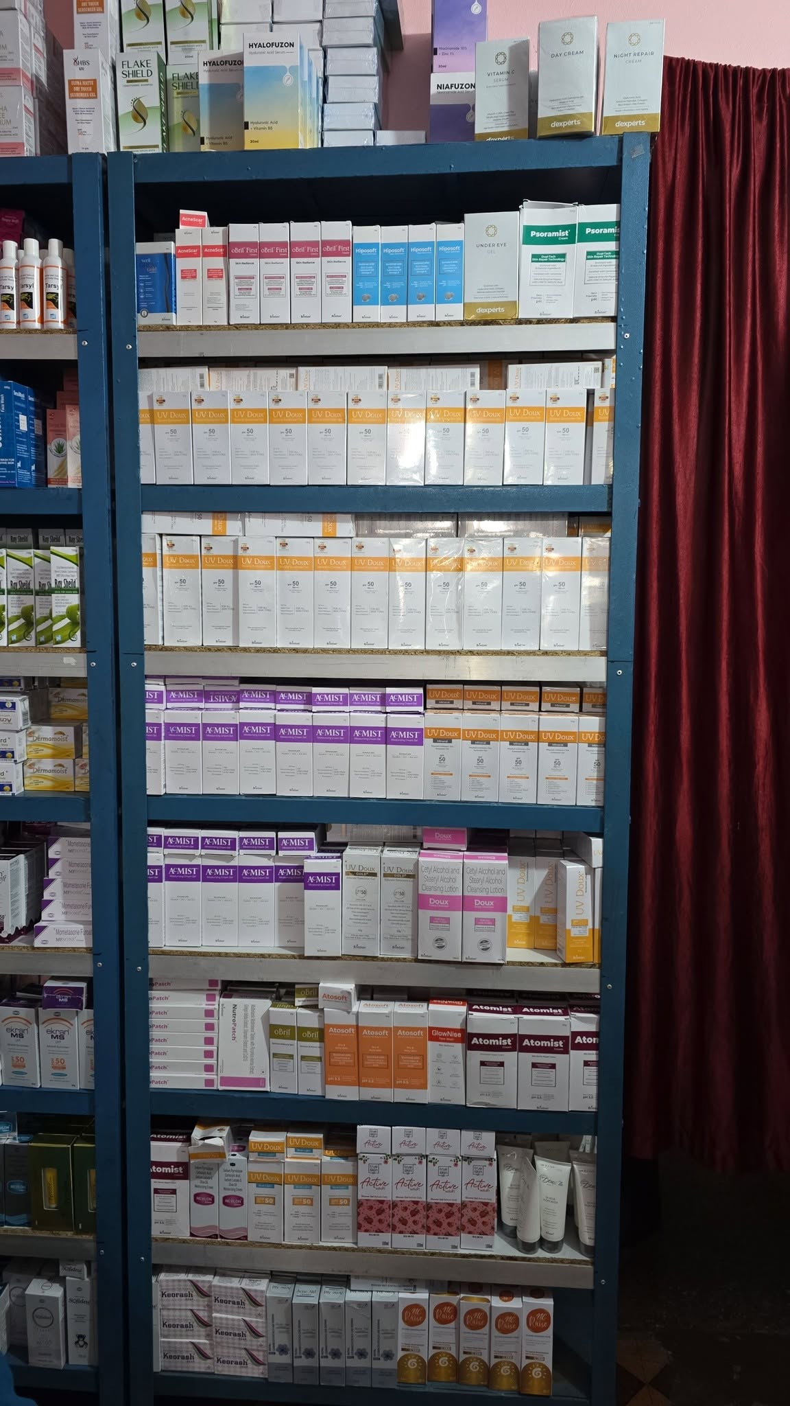 Shelves stocked with hair care, serums and dermatology products